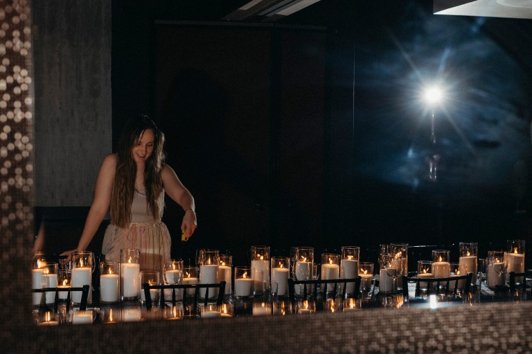 A girl lighting candles at a Nashville Event